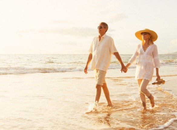 couple walking on the beach | SeaShore Realty