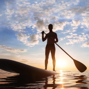 person doing stand up paddleboard | seashore realty