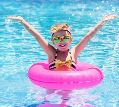 young girl in swimming pool with a ring float | SeaShore Realty
