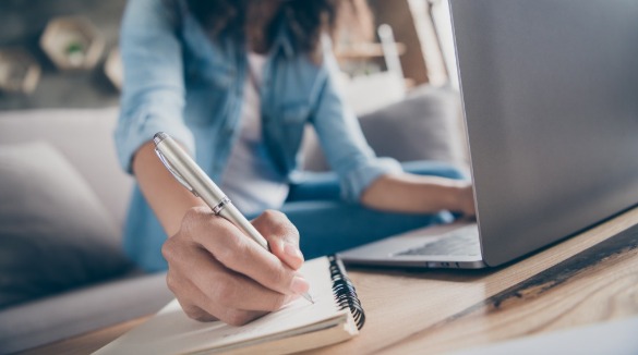 woman taking notes and using computer | SeaShore Realty