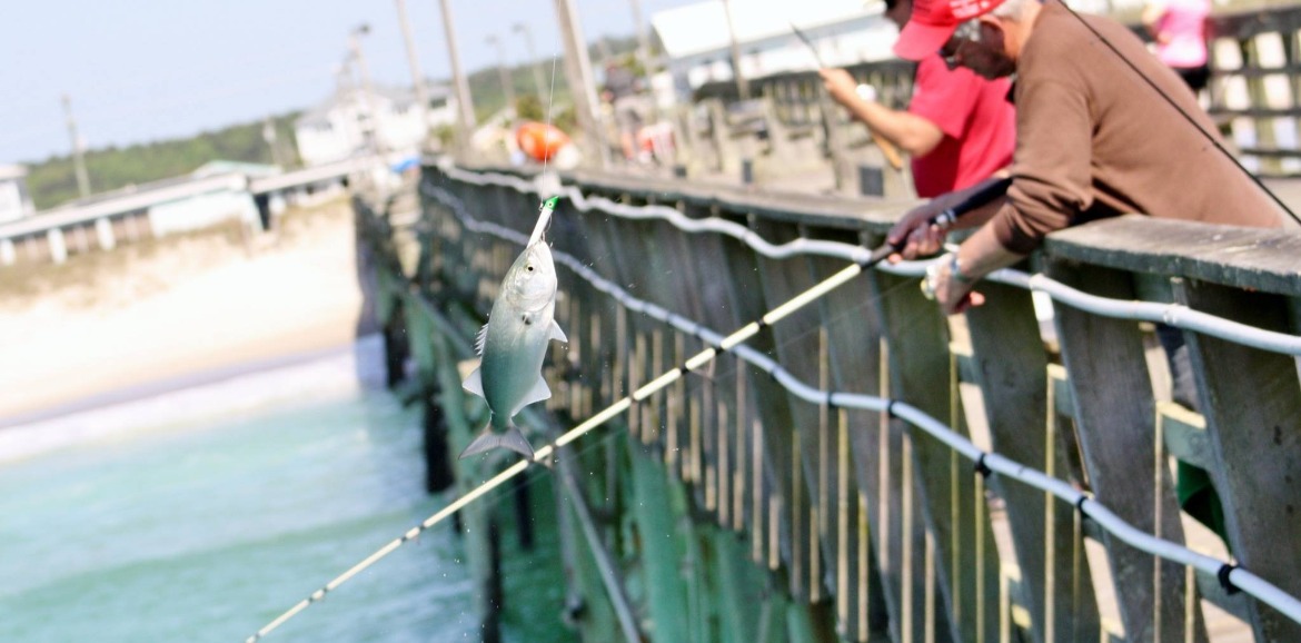 men catching fish off the Jolly Roger Pier in Topsail Beach | SeaShore Realty