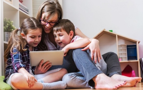 kids using tablet with their mom | SeaShore Realty