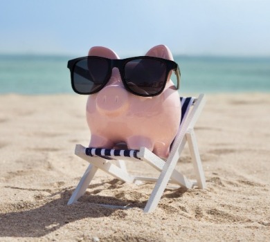 piggy bank sitting on the beach | SeaShore Realty