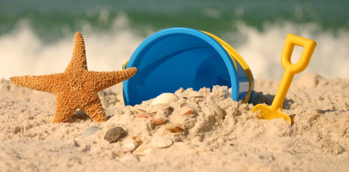 bucket, shovel, and shells on the beach | SeaShore Realty