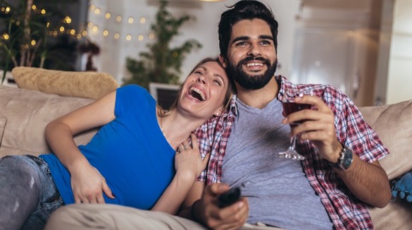couple watching television in their vacation rental | SeaShore Realty