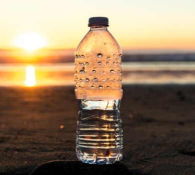 bottle of water on the beach | SeaShore Realty