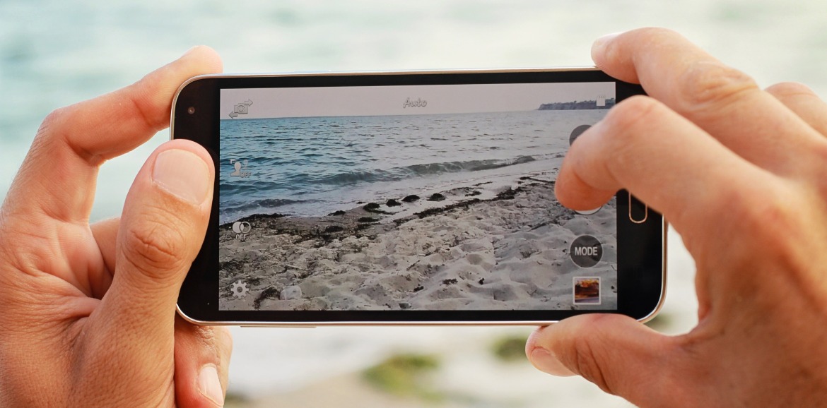 person taking picture of beach with cell phone | SeaShore Realty