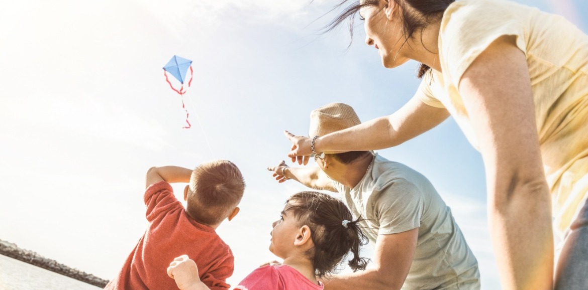 family flying kite on topsail beach | Seashore Realty
