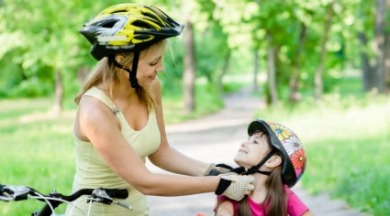 mother putting helmet on daughter | SeaShore Realty