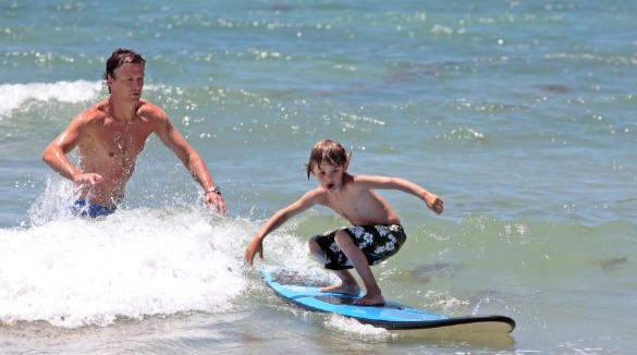 father & son surfing in topsail island, nc| Seashore Realty