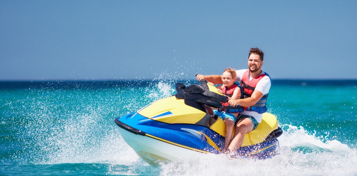 father and son on a jet ski | seashore realty