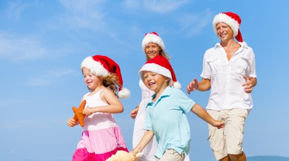 family on the beach wearing santa hats | SeaShore Realty